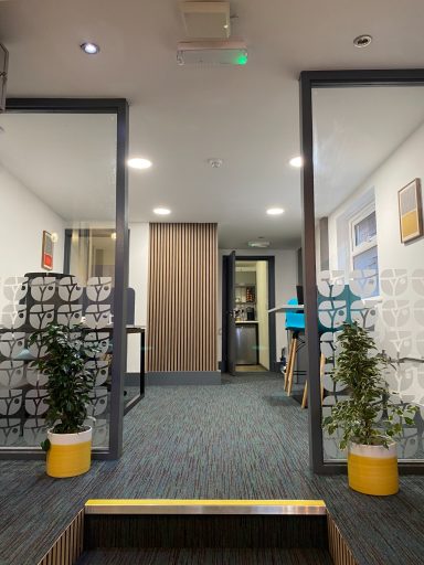 View of back office area of Connect Neston, including dividers and walkway through to kitchen
