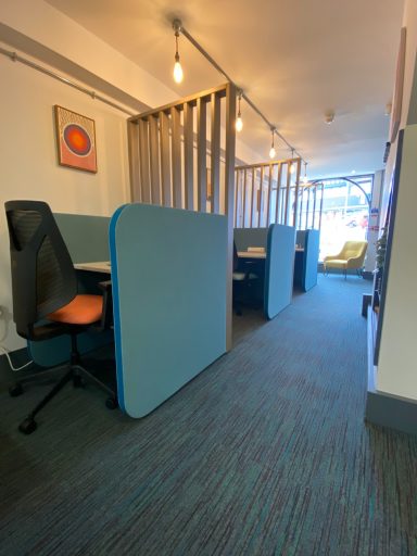 Single hot desk pods with chair and dividers between