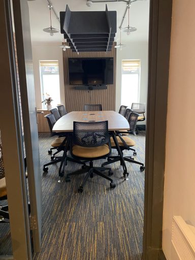 Door shot of the board room showing a large boardroom desk set up and chairs